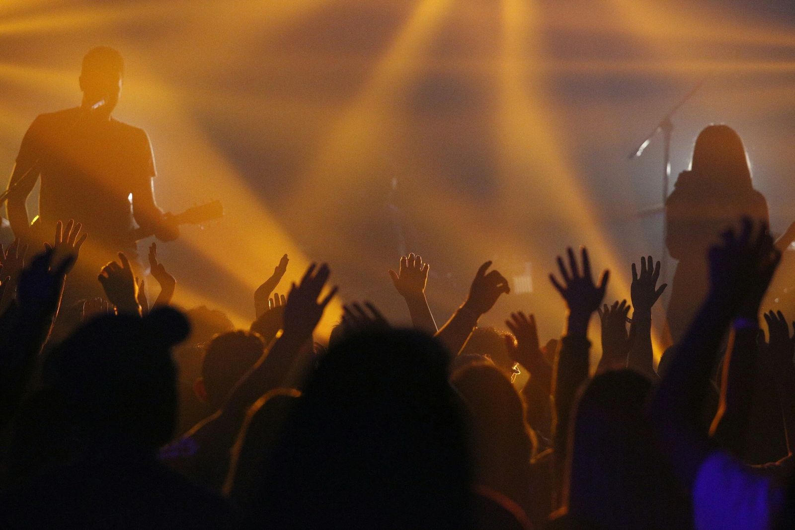 A concert crowd under stage lights