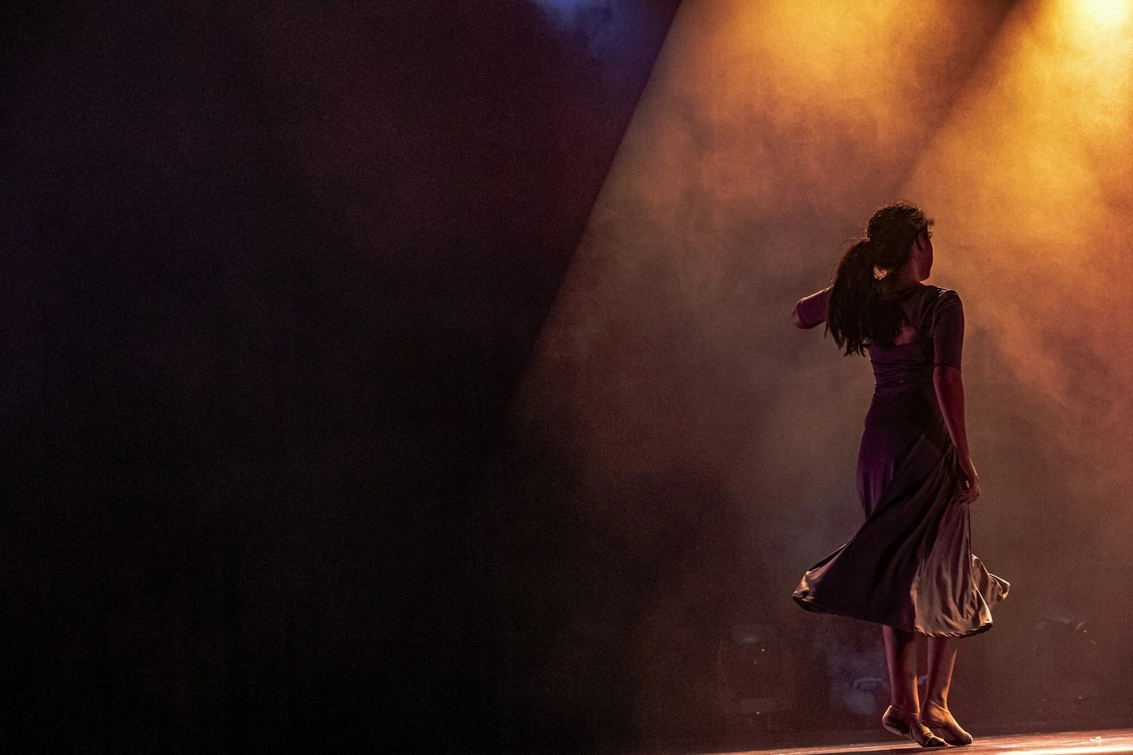 A performer on a spotlit stage